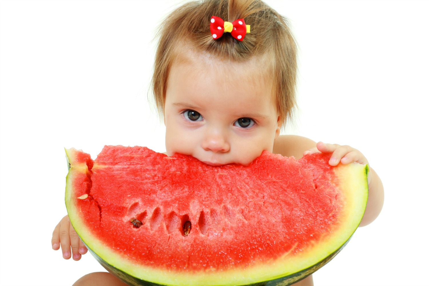 Baby girl eating a gigantic slice of watermelon - my tips for travel with a baby, including food and drink on planes